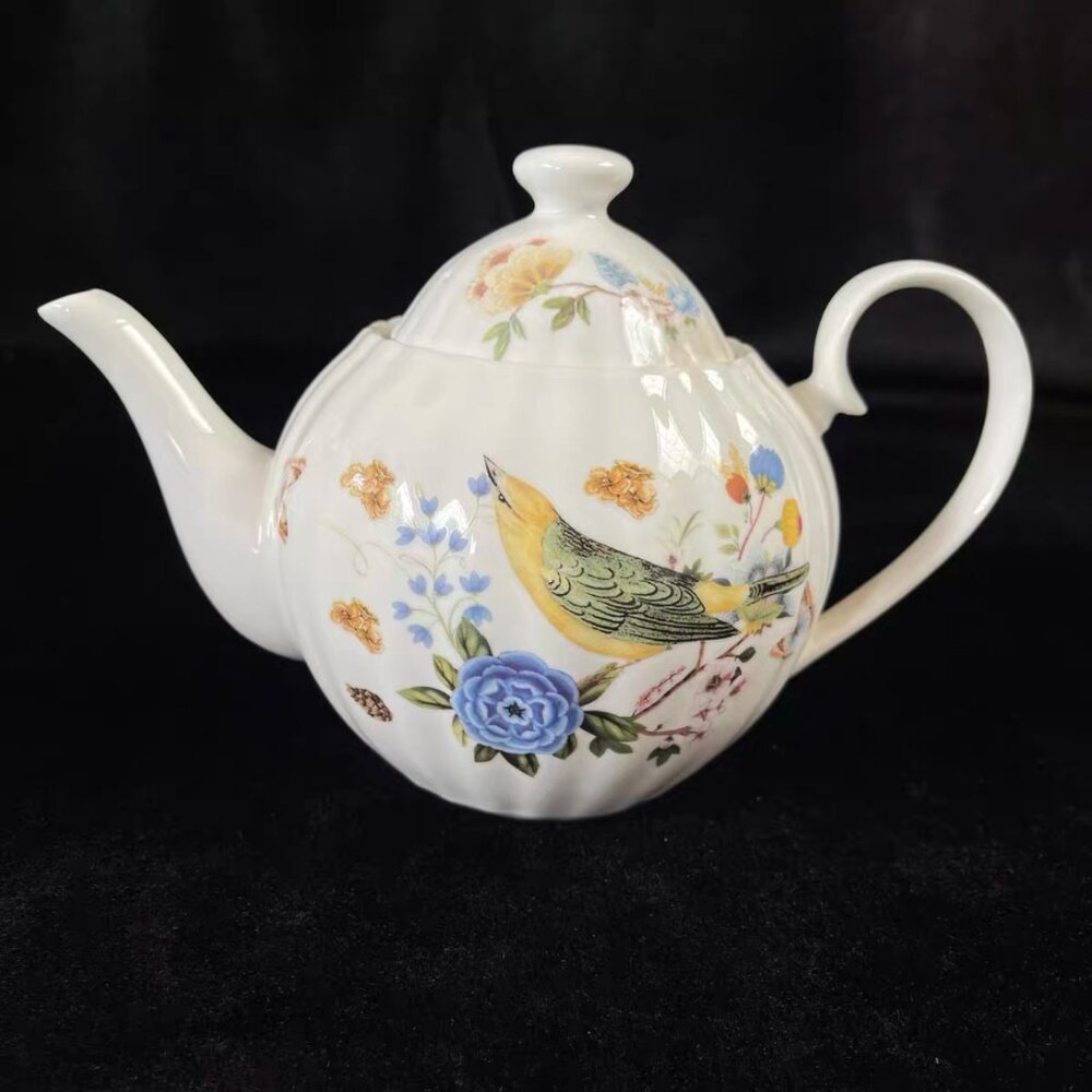 Ceramic teapot with a unique shape and subtle artwork.